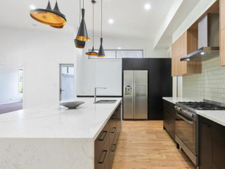 A modern kitchen with a huge benchtop can create a stylish and functional space for cooking, dining, and entertaining.