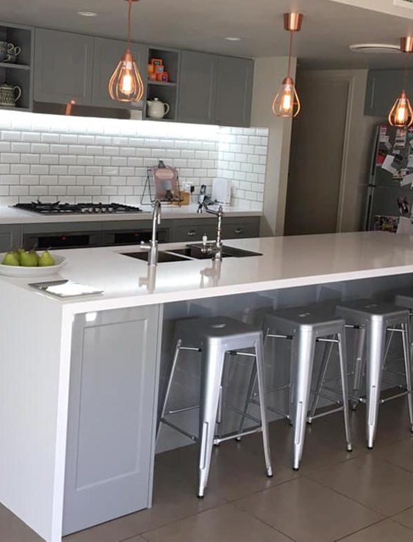 White kitchen cabinetry and stone benchtop designed installed by Gecko Kitchens, licenced kitchen builder in Kedron, Brisbane.
