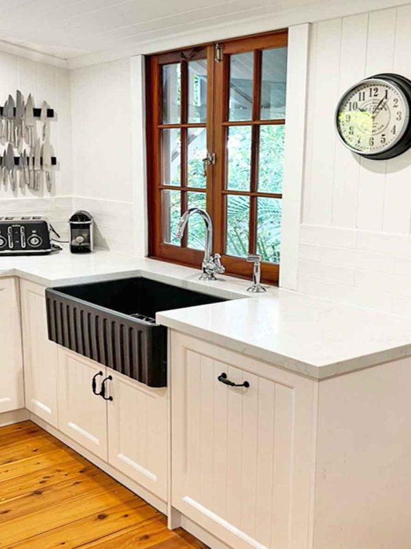White kitchen with black farmers sink installed by kitchen builder Gecko Kitchens in Kedron, Brisbane.