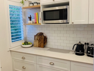 Beautiful white kitchen with Ceaserstone Clambshell Benchtop Beautiful white kitchen with Ceaserstone Clambshell Benchtop