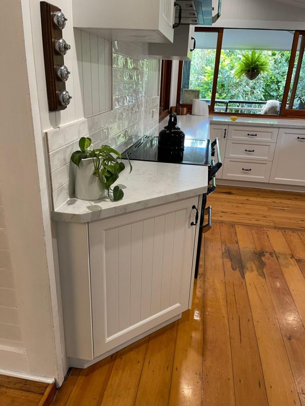 White kitchen with stone benchtops designed and installed by licenced kitchen builder Gecko Kitchens in Kedron, Brisbane.