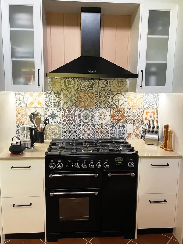 Kitchen renovation in East Brisbane featuring a kitchen servery to the verandah, fold back windows and topped off with Moroccan-style patterned tiles.