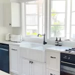 White kitchen with black and white appliances with a white Farmhouse twin sink. Designed and built by Gecko Kitchens in Kedron, Brisbane.