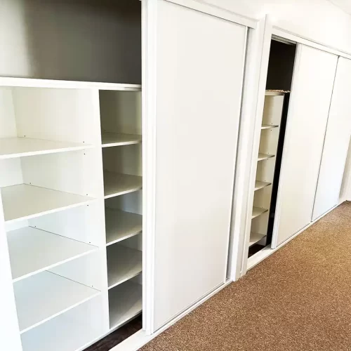 Custom built in wardrobes with sliding doors and lots of shelfing designed and built by Gecko Kitchens in Kedron, Brisbane.