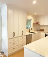 Kitchen cupboard with bi fold doors custom designed and installed by Gecko Kitchens Kedron