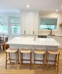 Kitchen island bench with stone benchtop and white cabinetry installed by Gecko Kitchens, Kedron