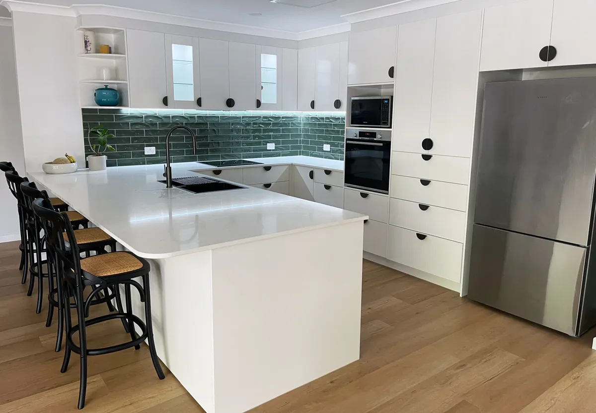 Glass display units above the sink can showcase treasures Adding charm and practicality to this kitchen renovation, the glass display units above the sink can showcase treasures, illuminated by LED strip lighting for a radiant glow.