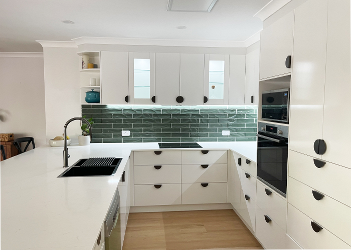 White kitchen renovation featuring green tiles, and stone benchtop by Gecko Kitchens in Upper Kedron, Brisbane.