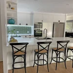 Chic Carpathian metallic-finish half-moon handles beautifully complement the Polytech Classic White Sheen Cabinetry and Doors.