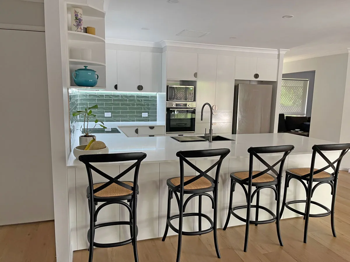 Chic Carpathian metallic-finish half-moon handles beautifully complement the Polytech Classic White Sheen Cabinetry and Doors.