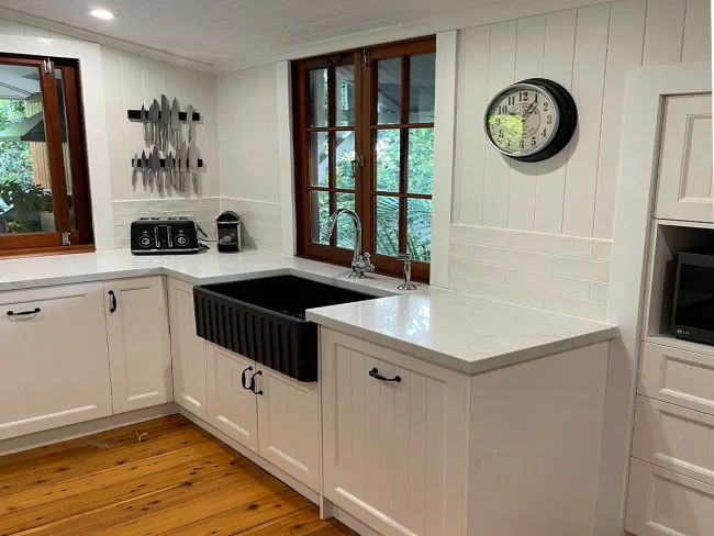 Black farmhouse sink Black farmhouse sink in this white kitchen renovation by Gecko Kitchens looks amazing .