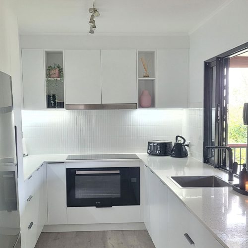 Kitchen Renovation Brisbane Northside | Gecko Kitchens White kitchen renovation designed and built by Gecko Kitchens in Brisbane featuring a stone benchtop white tile splashback.