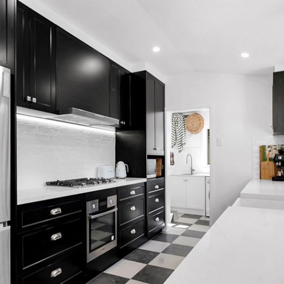 Polytec Thermolaminated Matt Black doors in the elegant Casino profile, paired with sleek YDL Shadow Grey benchtops, and a modern farmhouse butler sink
