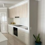 Polytec Classic White Matt cabinetry complemented by Soft Walnut timber doors, and YDL Stone benchtops 1
