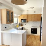 Modern Two-Tone Kitchen Design by Gecko Kitchens. Combining natural timber overhead cabinetry with clean white cabinetry below.
