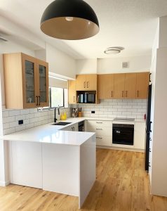 Modern Two-Tone Kitchen Design by Gecko Kitchens. Combining natural timber overhead cabinetry with clean white cabinetry below.